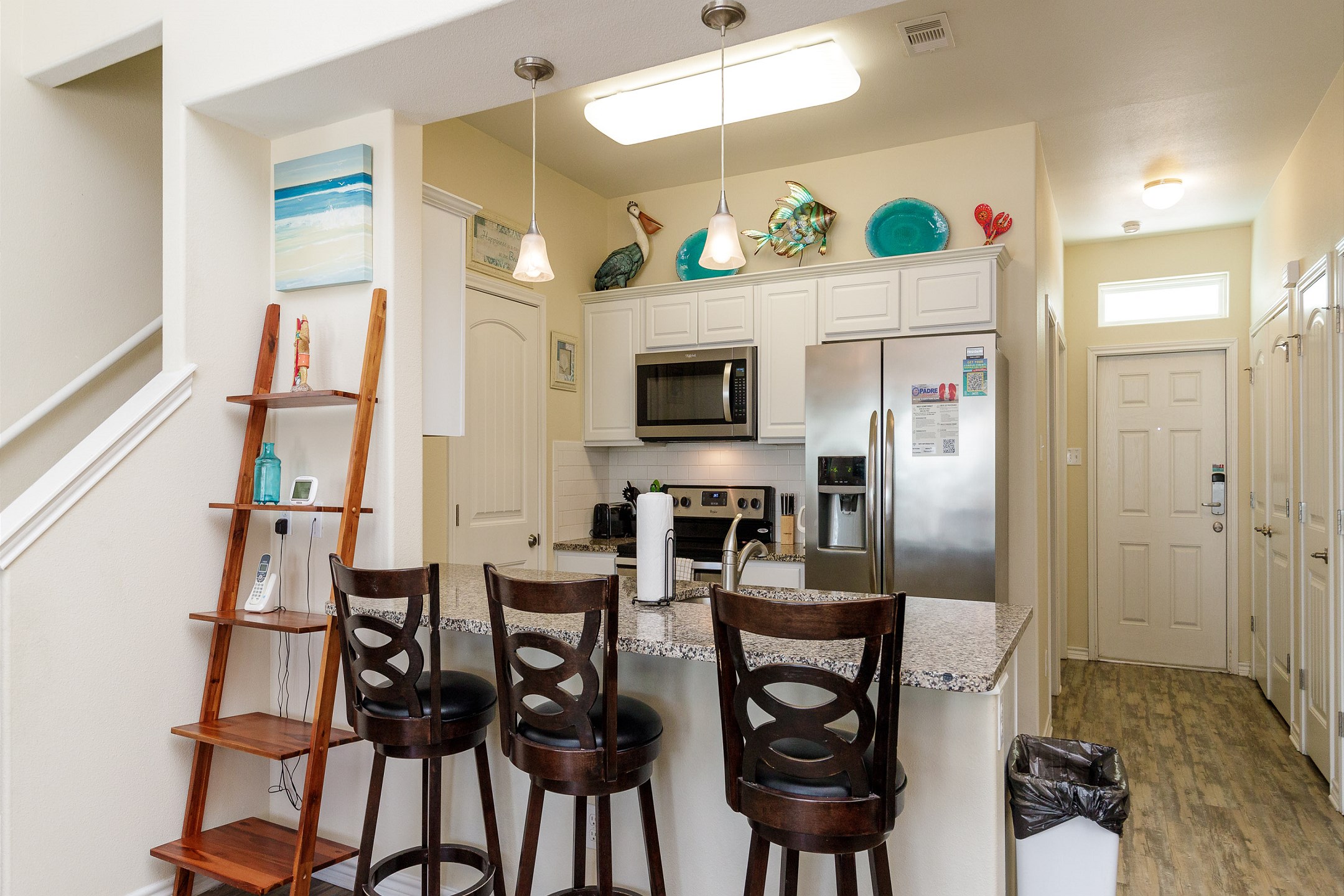 Kitchen area with breakfast bar that seats three