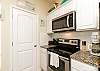 Kitchen area with 12-cup coffee maker and ample storage 