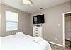 Master bedroom on the first floor with flat screen TV