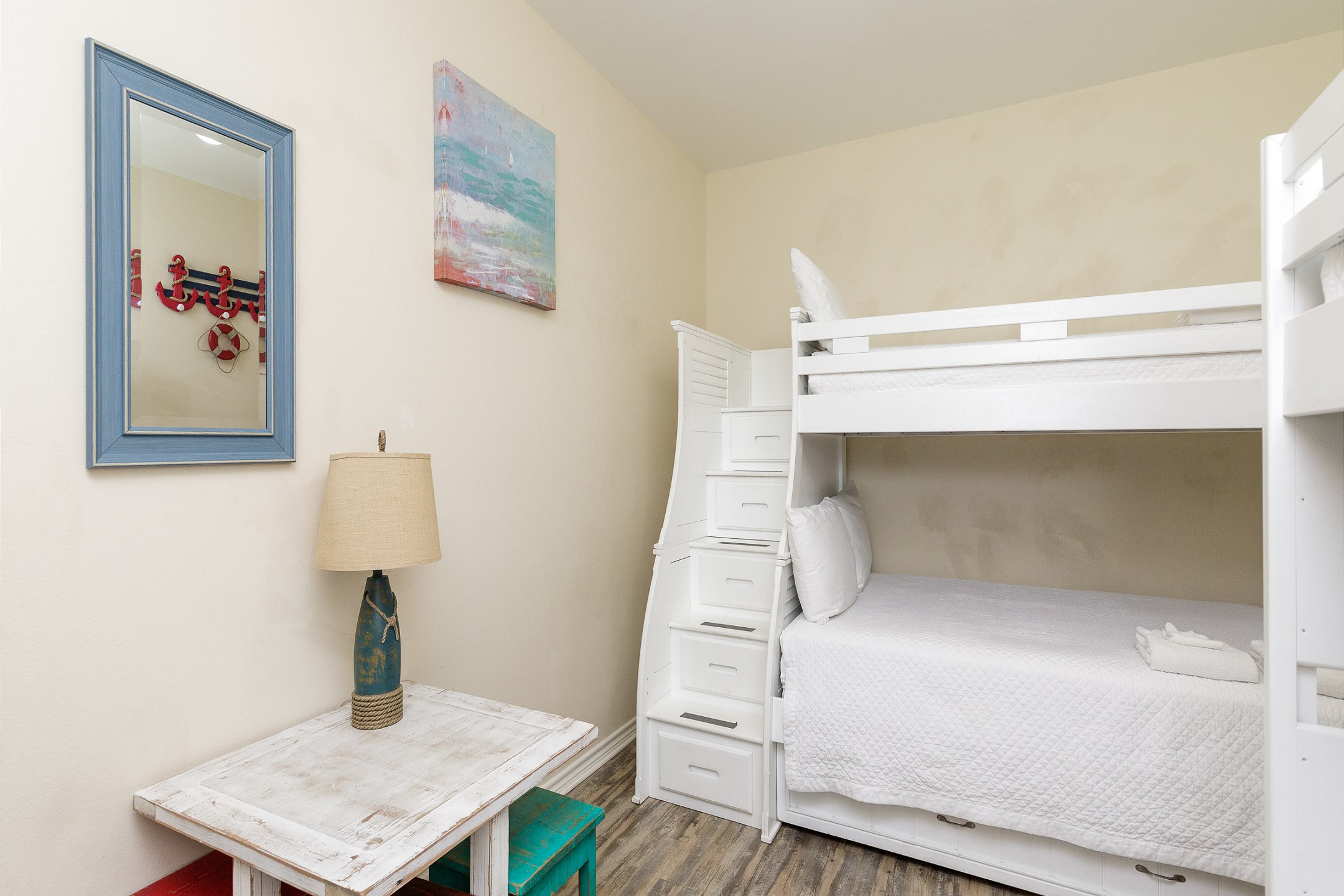 Bright and inviting third bedroom on the second floor featuring twin over full size bunk bed with twin trundle and twin size bunk beds, along with flat screen TV - perfect for kids or groups
