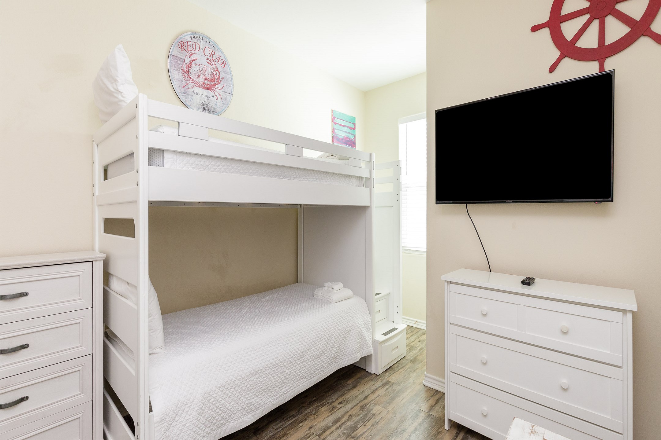 Bright and inviting third bedroom on the second floor featuring twin over full size bunk bed with twin trundle and twin size bunk beds, along with flat screen TV - perfect for kids or groups

