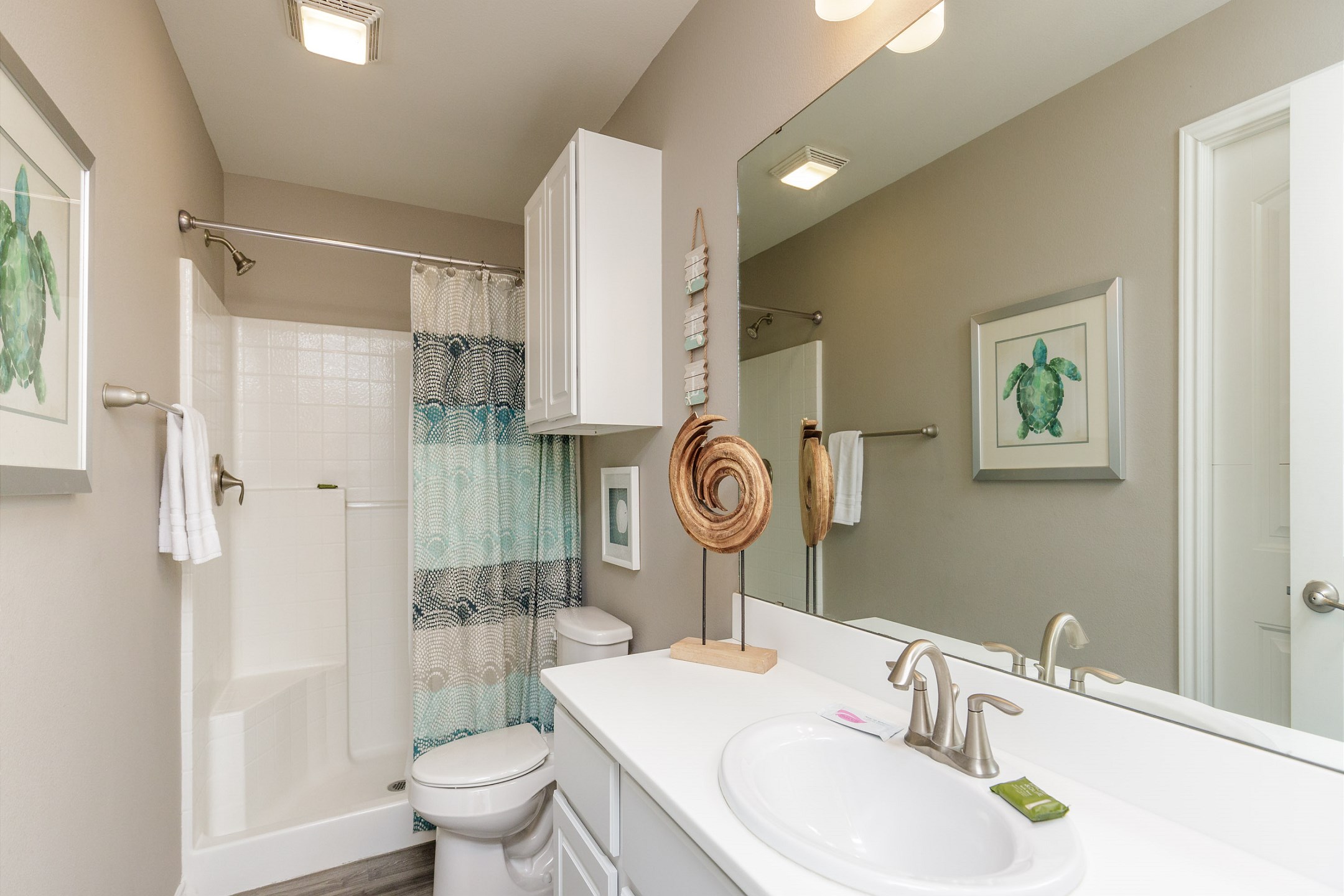 Bathroom on the first floor with walk in shower that shares access from master bedroom and hallway