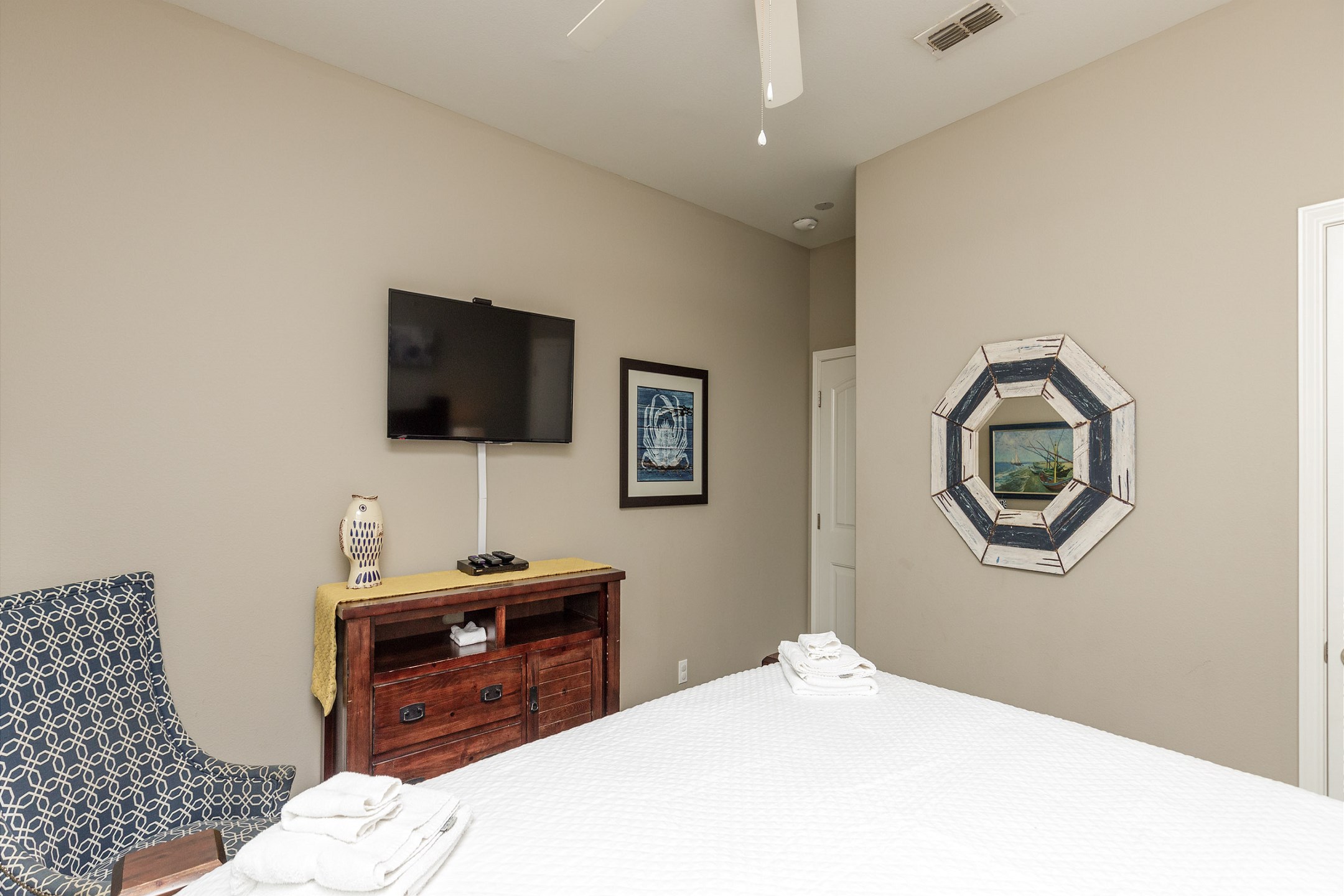 Second bedroom on the second floor with king size bed and flat screen TV. Currently the ceiling fan is not working, but there is a floor fan provided. 