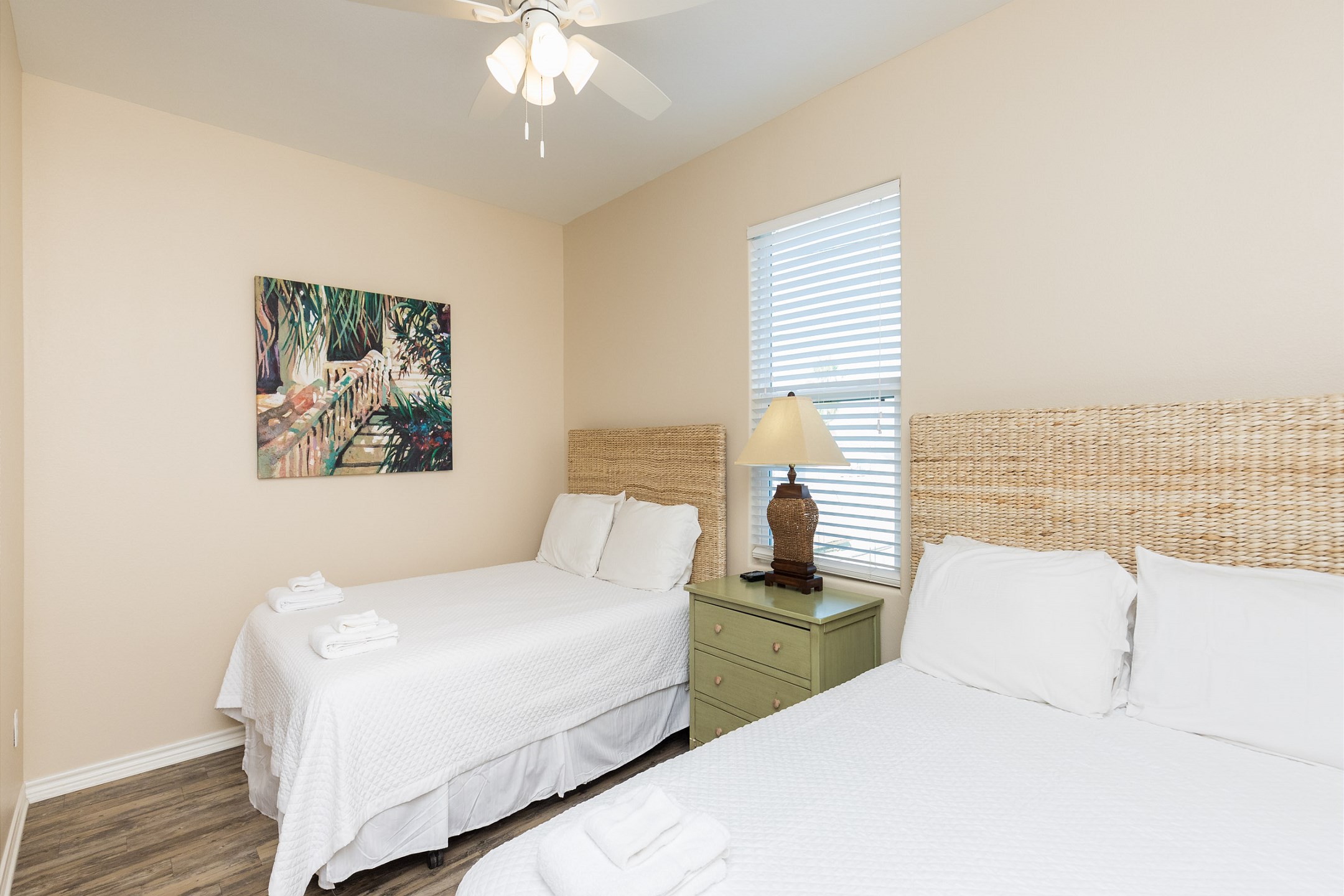 Second bedroom on the second floor with two queen size beds, a flat screen TV, and an ensuite bathroom