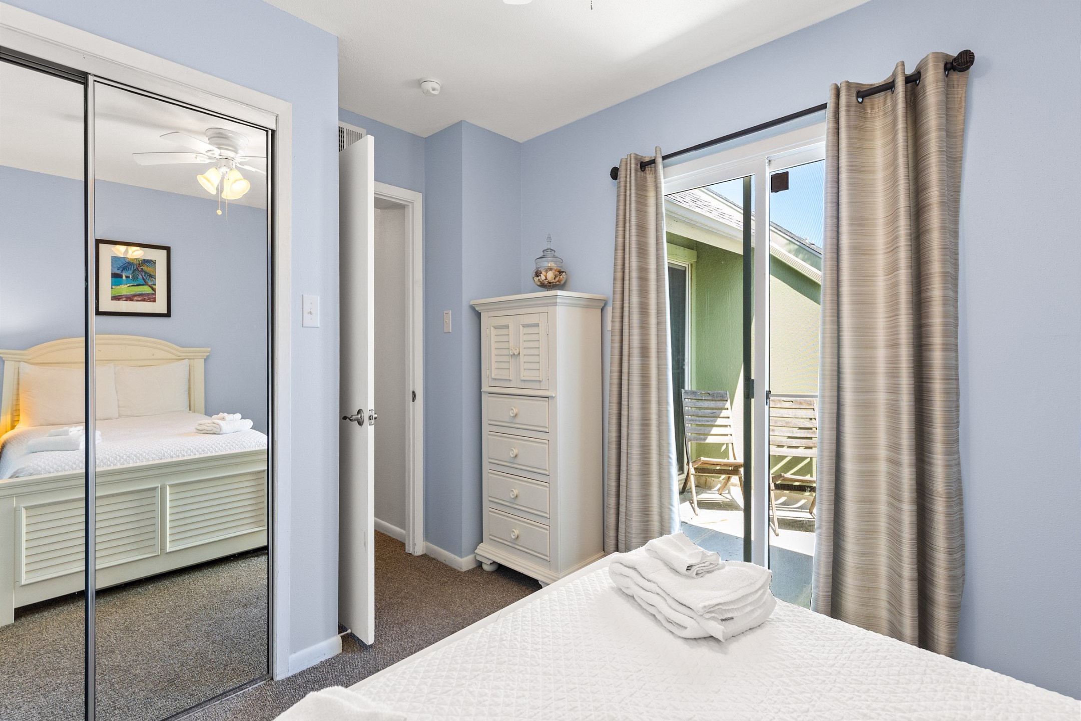 Third bedroom with a full-size bed, twin trundle, and private balcony access for added comfort and relaxation