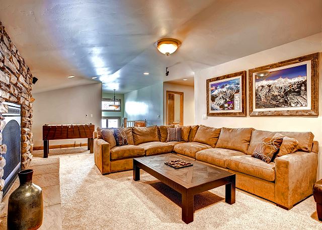 entertains with cozy couch, foosball, and large TV