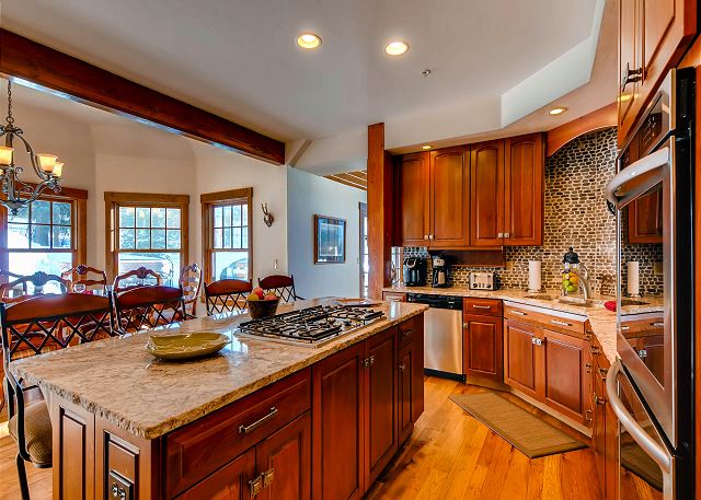 Kitchen with Island Cooktop and seating - open to dining area