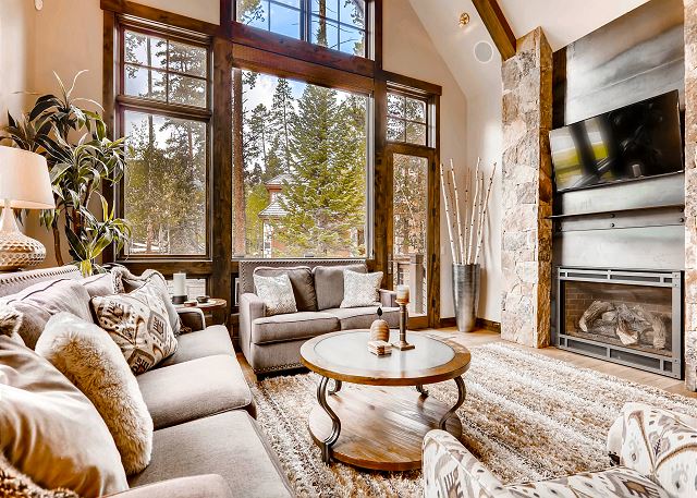 with gas fireplace, TV, cozy sofas and deck access