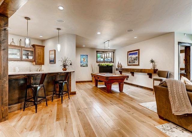 with pool table, cozy sectional, wet bar and TV!