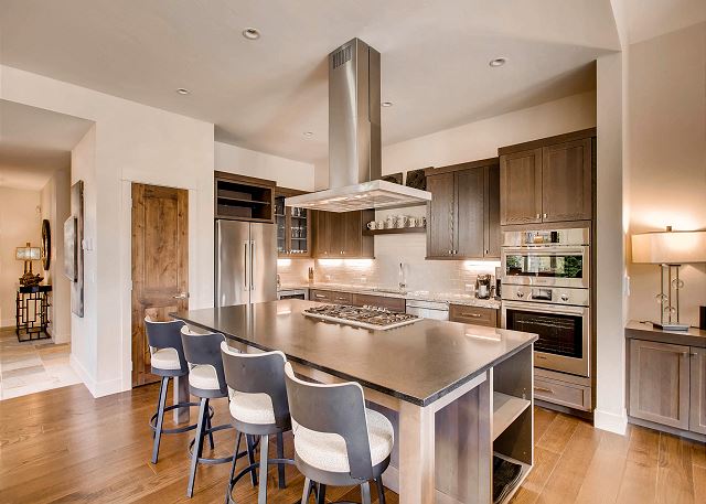which opens to the living and dining area and also offers additional seating for dining