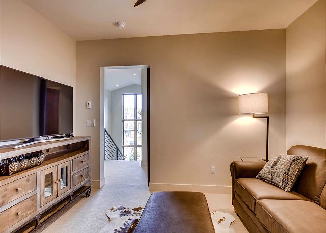 features privacy with the ability to close off the room, a large TV and queen sleeper sofa for 2