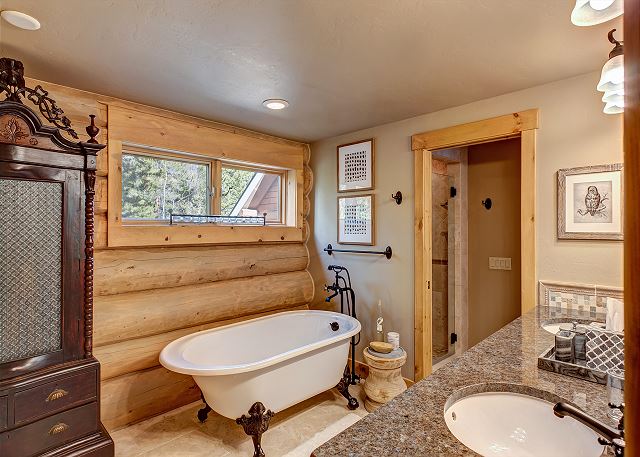 with soaking tub, separate shower, and dual sinks