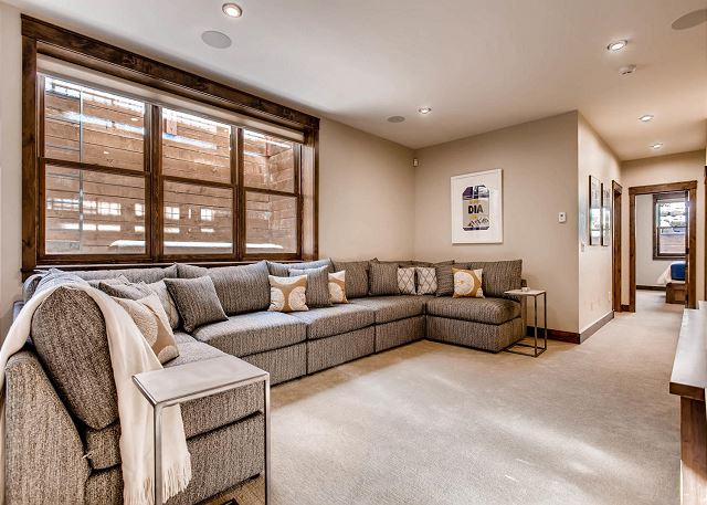 with large cozy sectional sofa and large TV with multiple cable viewing options