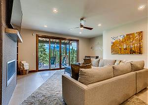 Lower den accesses spacious patio