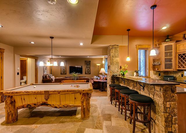 offers cozy sitting area with big TV, billiards table and bar area