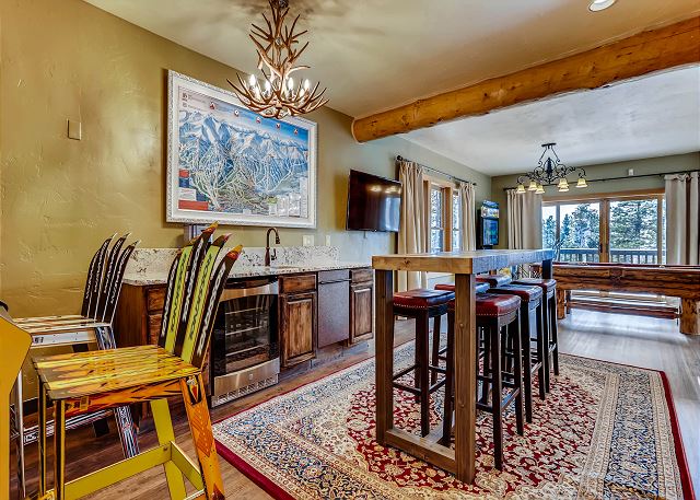 with wet bar, high top table seating, billiards, TV and arcade games