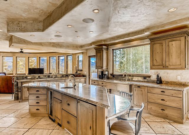features multiple sinks, full sized refrigerator and freezer, 2 dishwashers, a Wolf gas range and panoramic mountain views