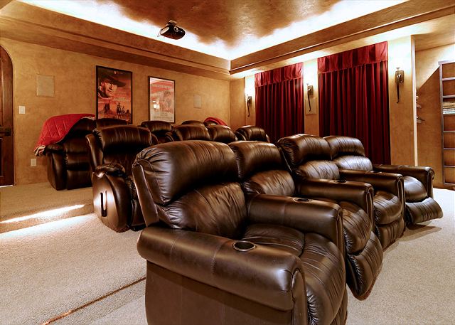 features a theatre room with seating in cozy recliners!