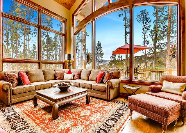 with large comfy sectional sofa and additional lounging chairs