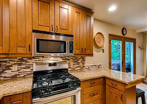 Kitchen with gas stove and bar seating