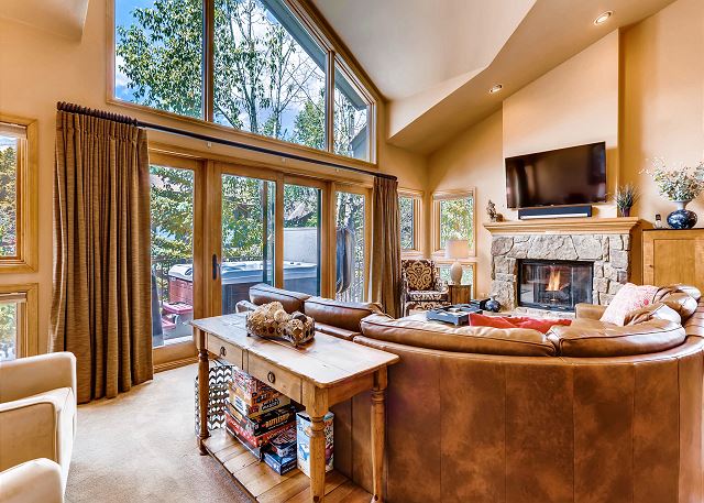 features TV, comfy sectional sofa, gas fireplace and floor to ceiling windows