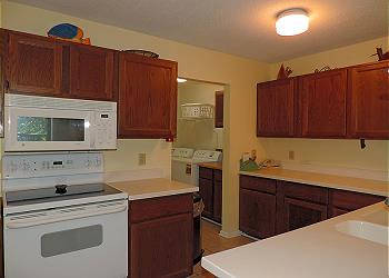 Fully Equipped Kitchen with Laundry Beyond