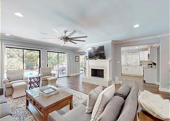Living Room with Slider Access to Private Deck and Pool Area