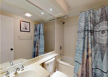 Guest Bathroom with Tiled Tub and Shower Combination