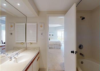 Primary Bathroom with Tiled Tub and Shower Combination