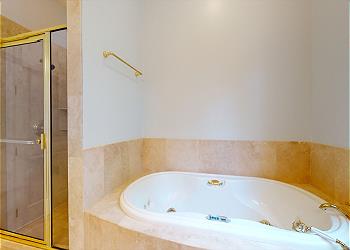 En-Suite Bathroom with Tiled Walk-in Shower and Tub