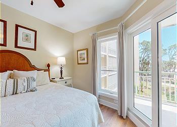 Primary Bedroom with View of the Ocean and Community Pool