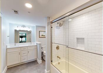 Guest Bedroom with Tiled Tub and Shower Combination