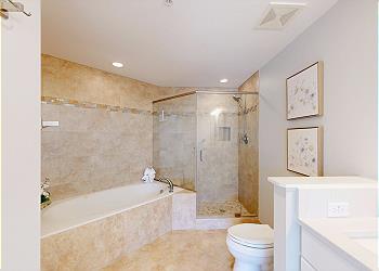 Primary Bathroom with Tiled Walk-in Shower and Tub