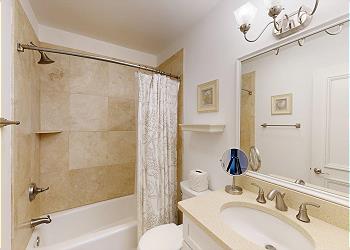 Guest Bathroom with Tiled Tub and Shower Combination