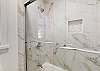 En-Suite Guest Bathroom with Tiled Tub and Shower Combination
