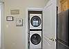 keep up with your beach towels with a stackable washer and dryer in the kitchen area. 