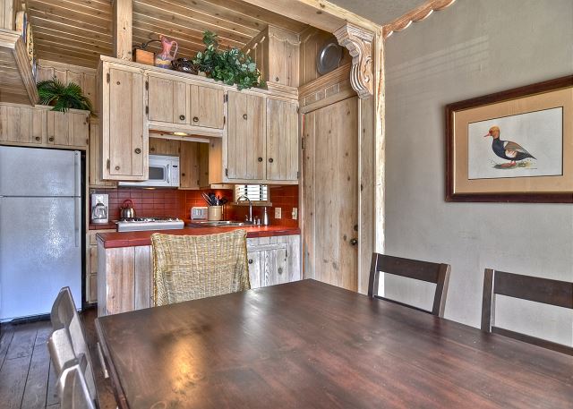 Dining area with a rectangular wooden table that seats 6 people.