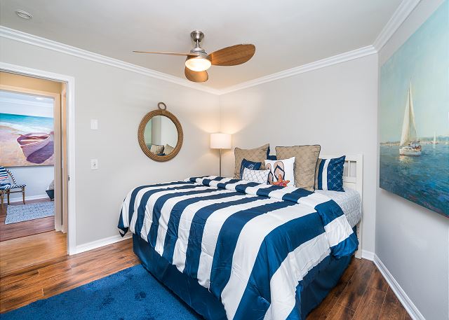 The second bedroom features a king-sized bed and has a flat-scre
