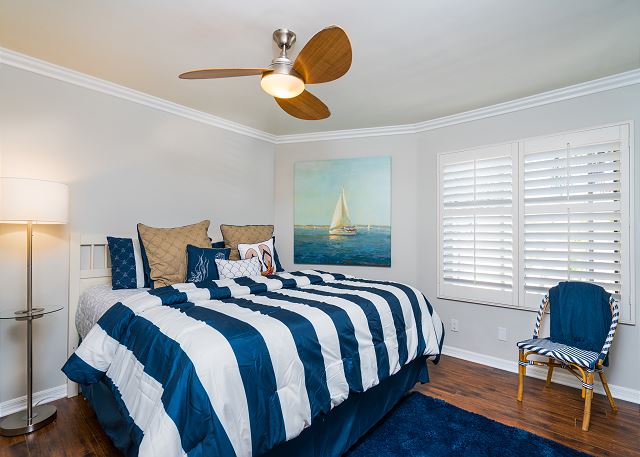 The second bedroom features a king-sized bed and has a flat-scre