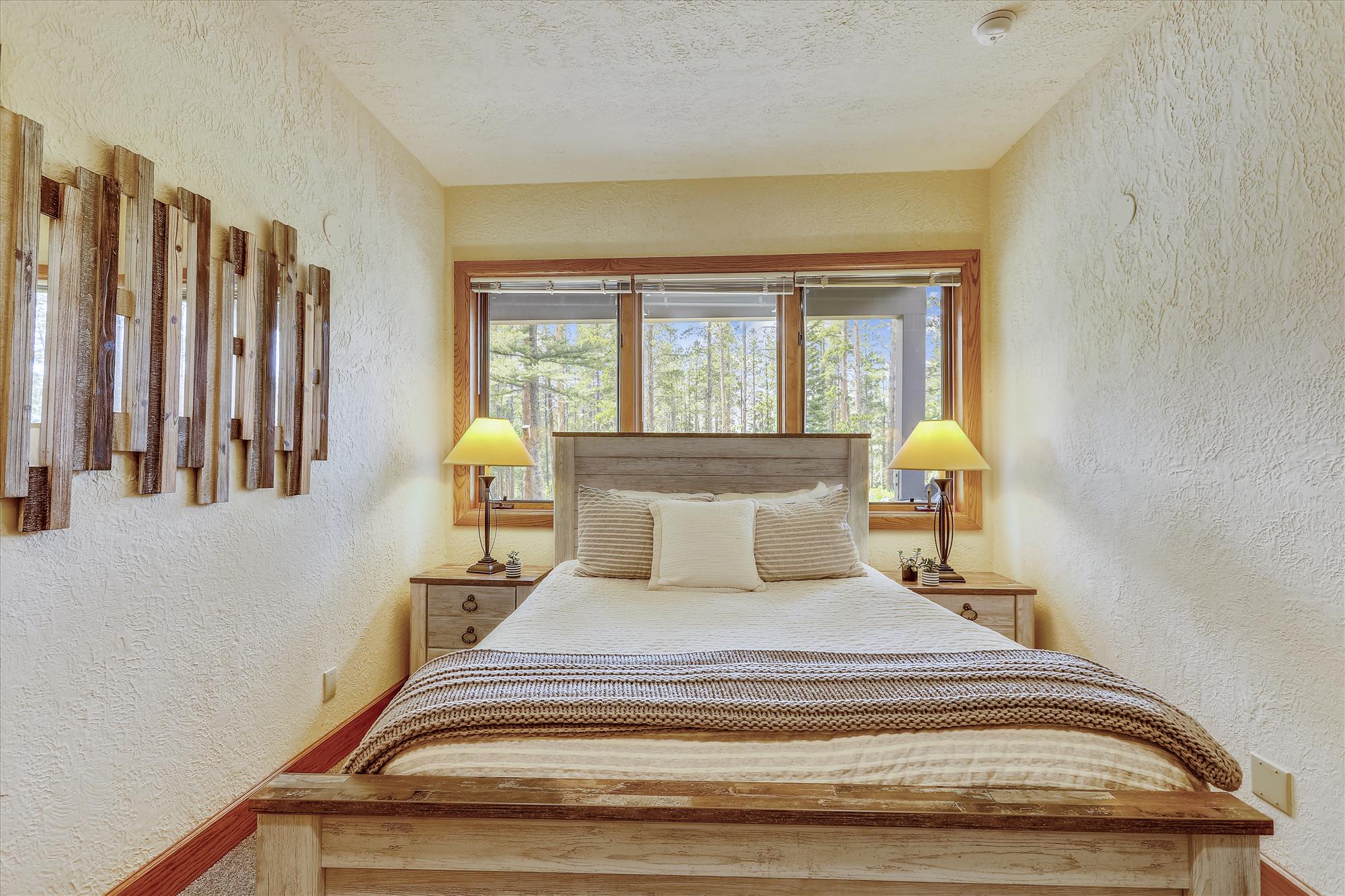 Bottom floor queen bedroom with a beautiful secluded view - Evergreen Lodge Breckenridge Vacation Rental