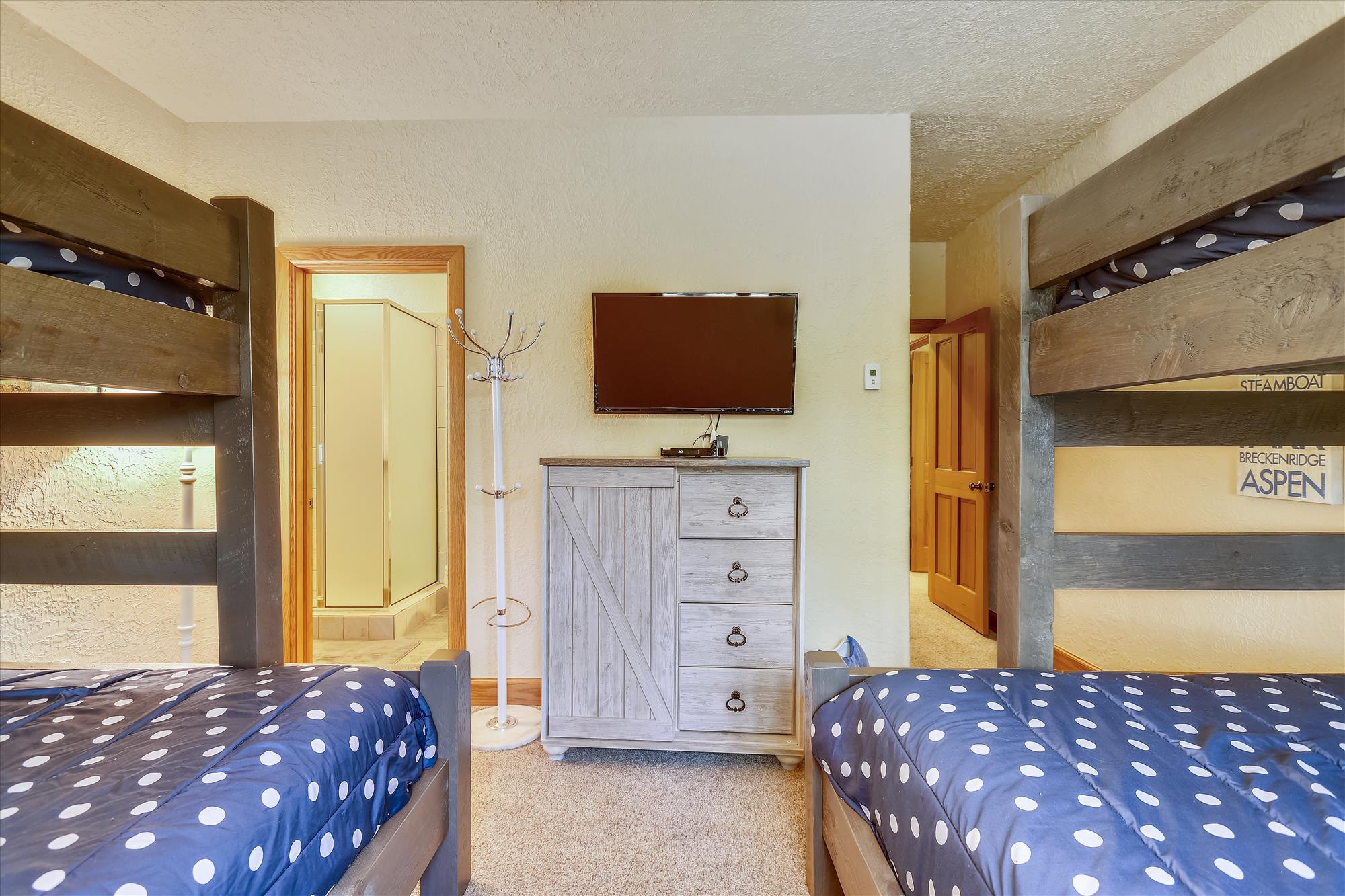 Two bunk beds with twin sized beds on top and full sized beds on the bottom, located on the bottom floor - Evergreen Lodge Breckenridge Vacation Rental