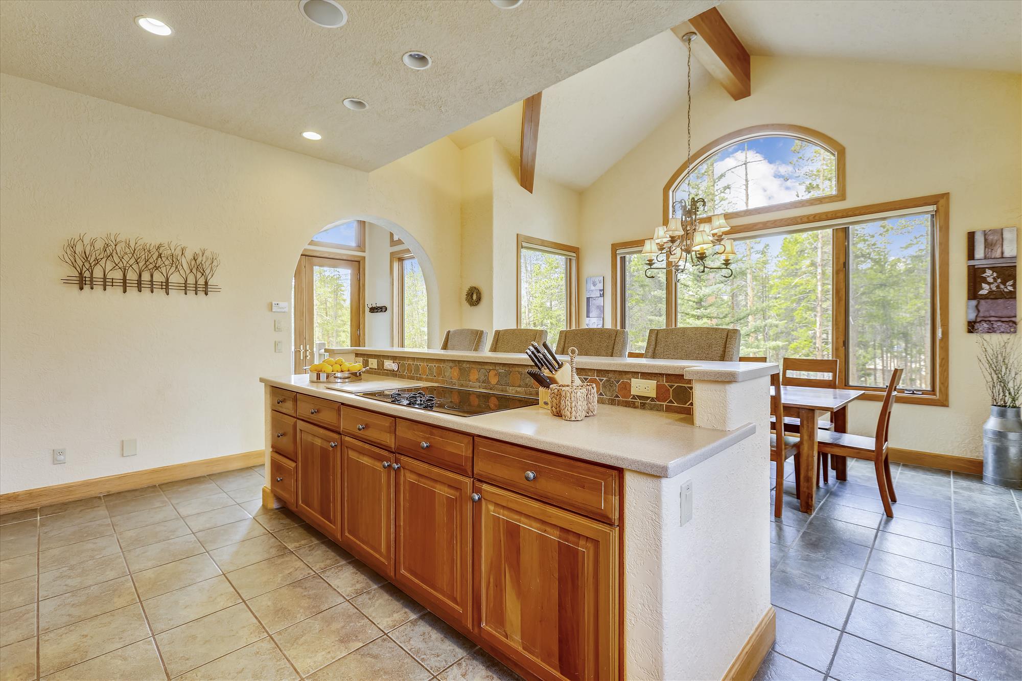Kitchen island with stovetop and bar seating - Evergreen Lodge Breckenridge Vacation Rental