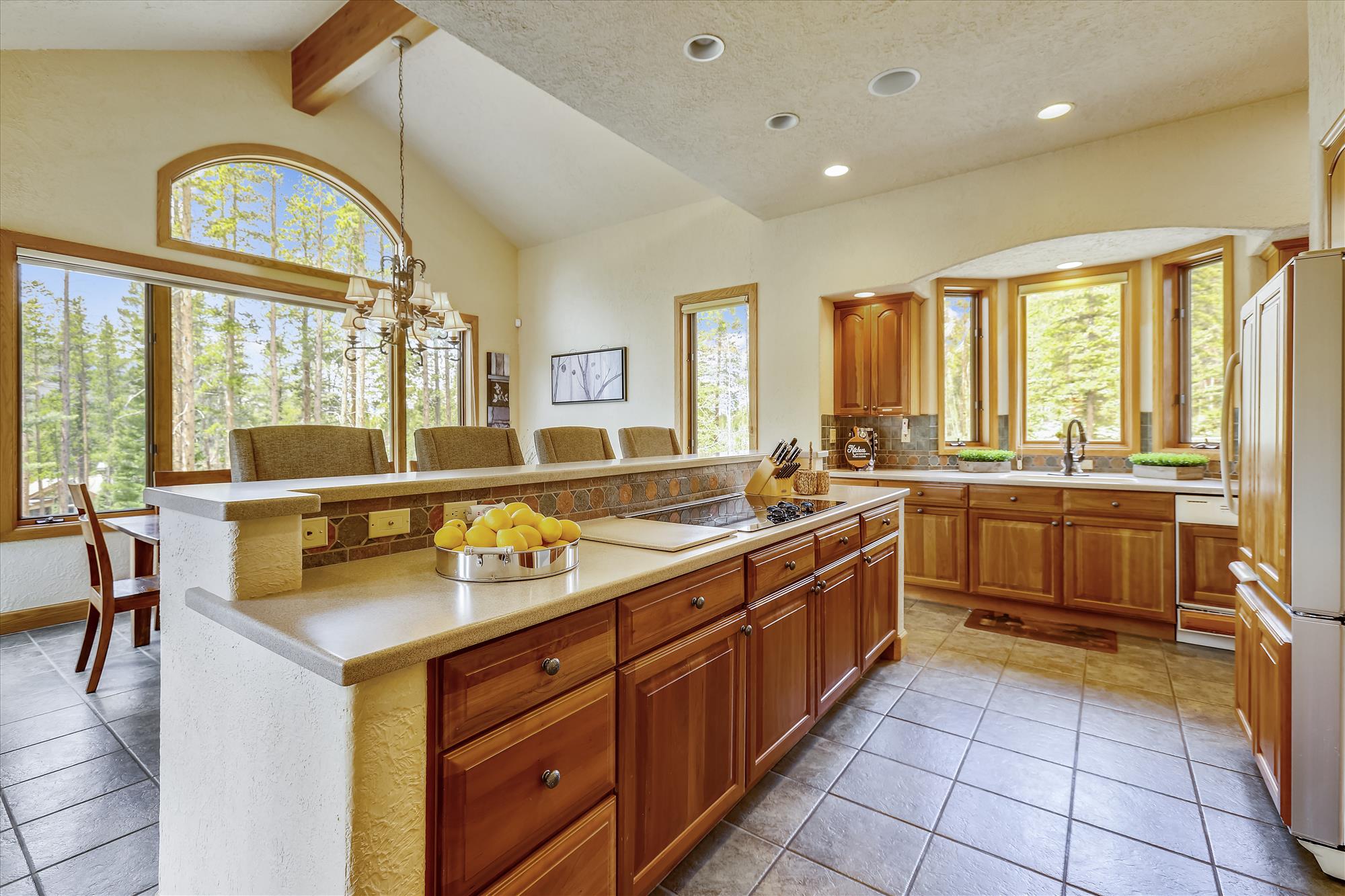 This kitchen boasts ample seating space and updated appliances for all of your cooking needs - Evergreen Lodge Breckenridge Vacation Rental