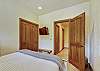 Queen bedroom with closet space and TV - Evergreen Lodge Breckenridge Vacation Rental 