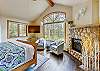 This master bedroom offers a large gas fireplace, flat screen tv and a seating area - Evergreen Lodge Breckenridge Vacation Rental 