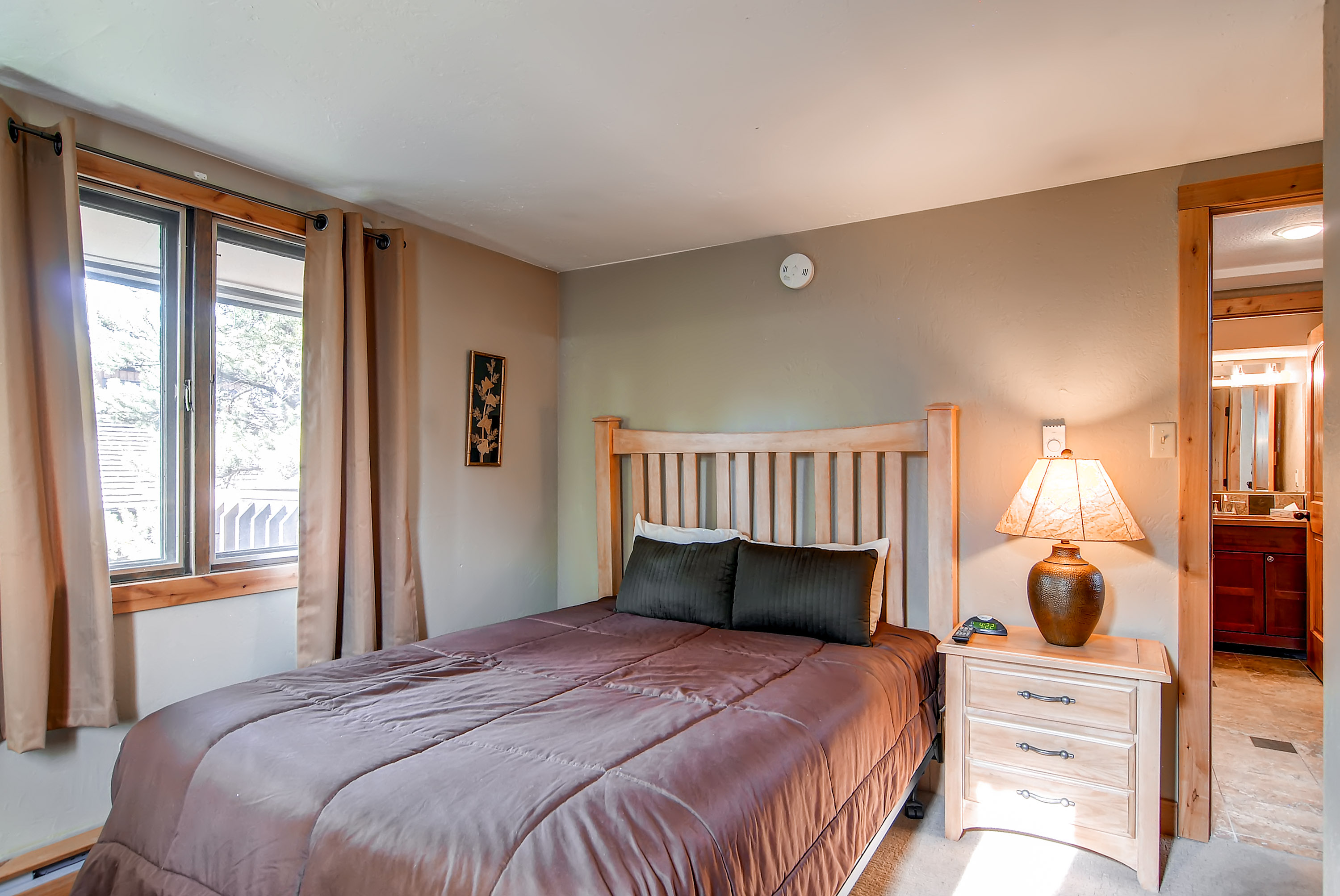 Queen bed in the main floor master bedroom - 4 O’Clock Lodge A16 Breckenridge Vacation Rental
