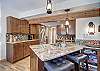 Enjoy cooking meals in the updated kitchen with stainless steel appliances - 4 O’Clock Lodge D26 Breckenridge Vacation Rental 