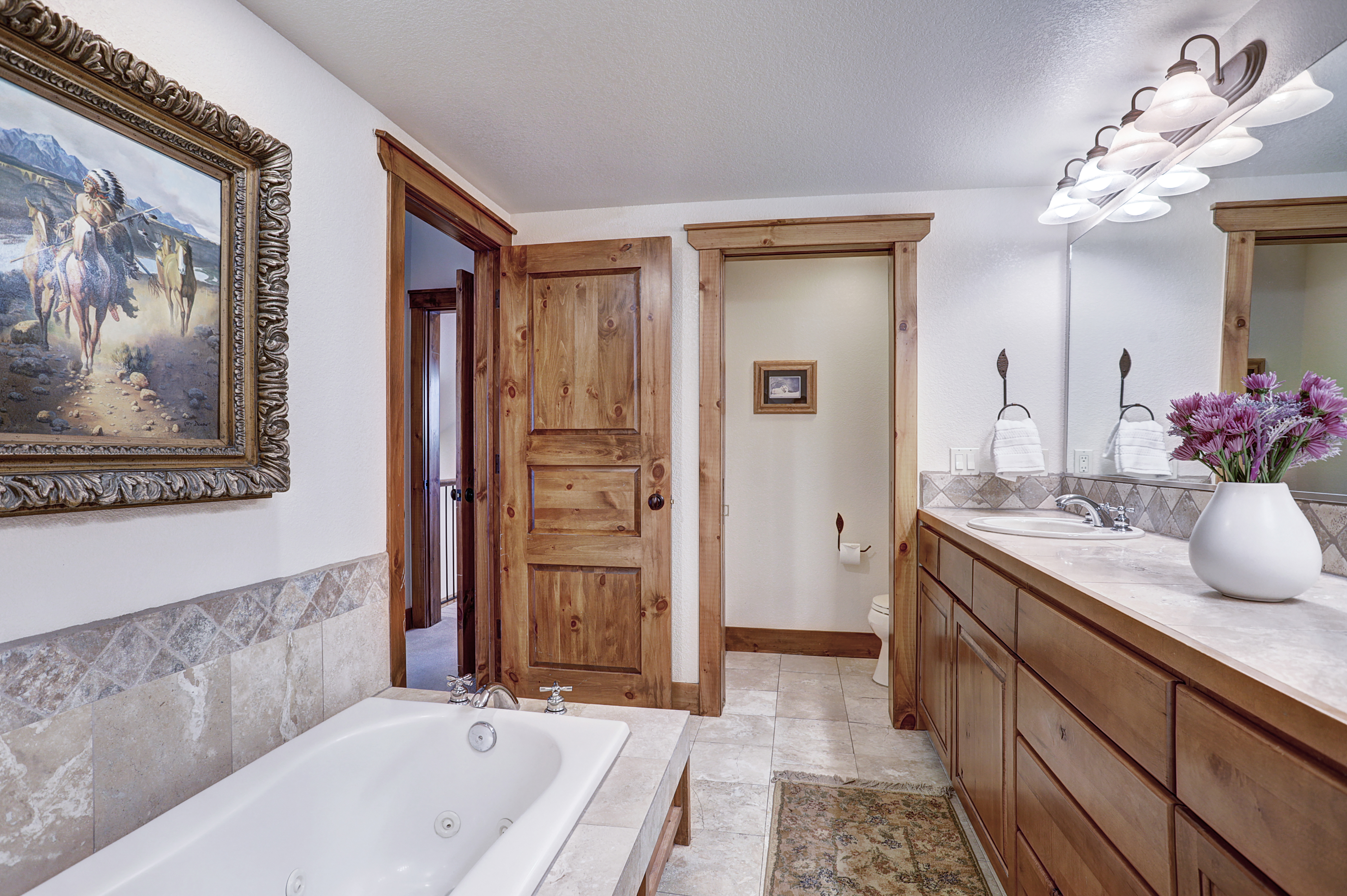 The master bathroom offers a large bathtub, walk in shower and double vanity sinks - Amber Sky Breckenridge Vacation Rental