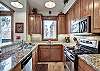 This spacious kitchen boasts updated stainless steel appliances and granite countertops - Amber Sky Breckenridge Vacation Rental 