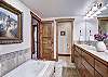 The master bathroom offers a large bathtub, walk in shower and double vanity sinks - Amber Sky Breckenridge Vacation Rental 